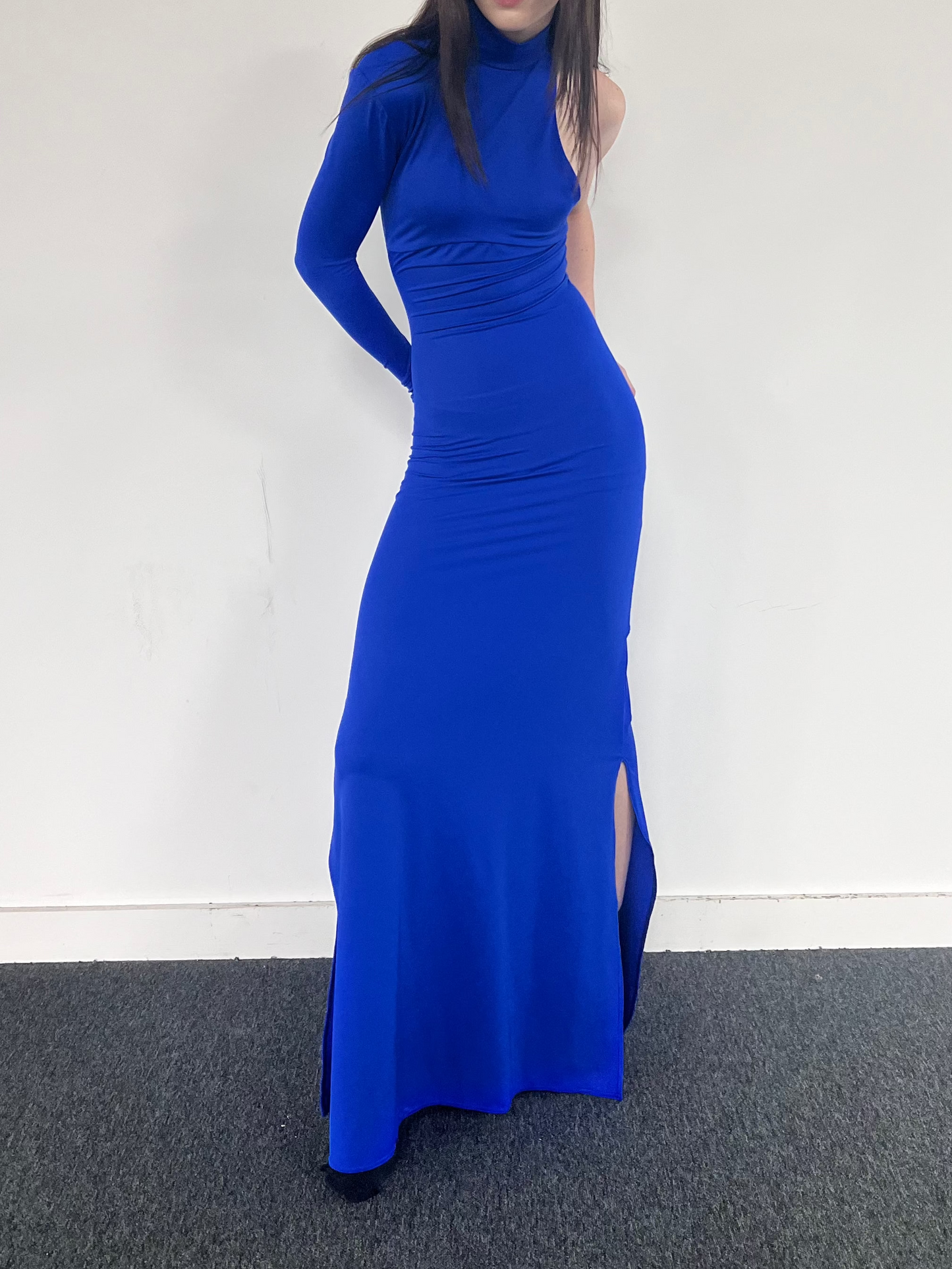 Electric blue Surge one-sleeve gown in ECONYL® technical jersey, worn on model.